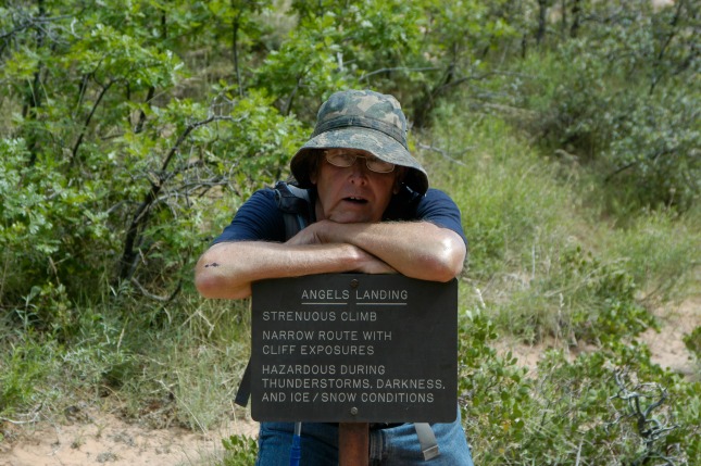 Grandpa resting on a sign