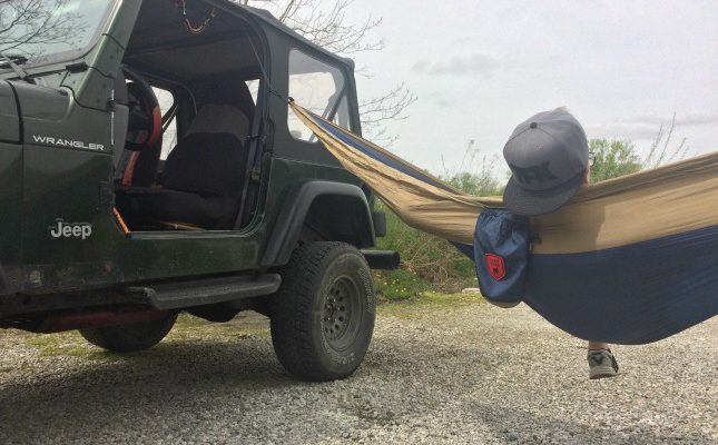 Gavin sitting in hammock with his Jeep